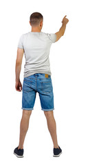 Back view of going handsome man in shorts pointing.