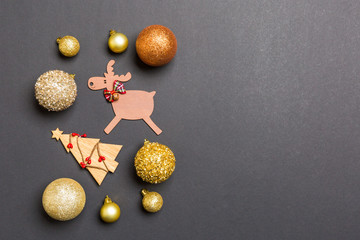 New Year composition made of baubles, reindeer and other decorations on colorful background....