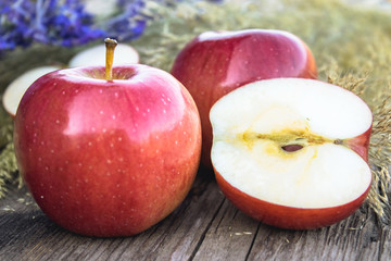 Fresh ripe red apples lie on a wooden table. Vitamins and a healthy diet. Vegetarian concept.