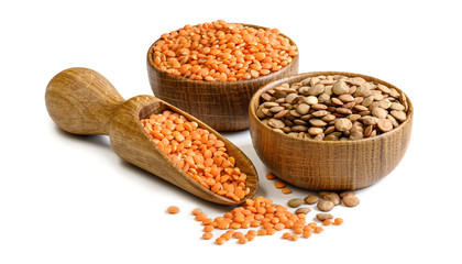Lentils in a wooden bowls and scoop isolated on white background. Full depth of field - obrazy, fototapety, plakaty