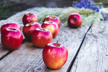 A lot of apples on a wooden table. Vitamins and a healthy diet. Vegetarian concept.