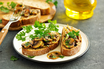 Bruschetta with fried mushrooms with onions and parsley.