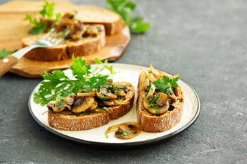 Bruschetta with fried mushrooms with onions and parsley.