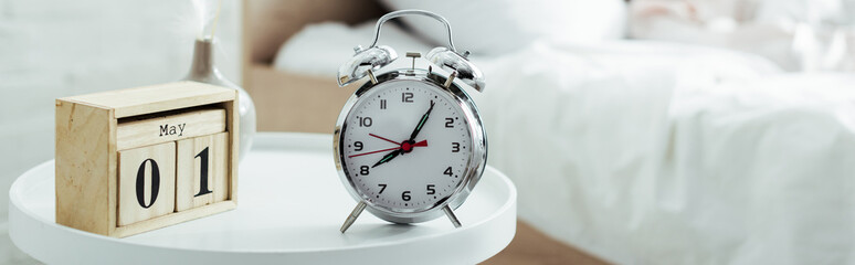 selective focus of alarm clock and calendar in bedroom at morning