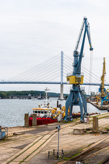 View of the commercial harbour of Stralsund with cranes and tugboat.