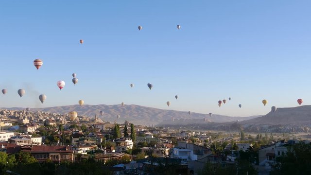 Colorful Hot Air Balloons flying over Goreme town in Cappadocia, Turkey