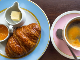 Continental breakfast with fresh croissants, apple jam, butter, coffee