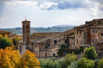 Old houses in Certaldo,  small town and comune of Tuscany, Italy. autumn foliage, grey stone houses