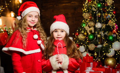 Fototapeta na wymiar Be Jolly and make good cheer for Christmas comes but once a year. Cute girls sisters friends celebrate christmas at home. Magic time. Children join christmas carnival party. Waiting for Santa claus