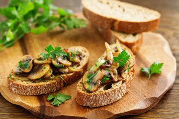 Bruschetta with fried mushrooms with onions and parsley.