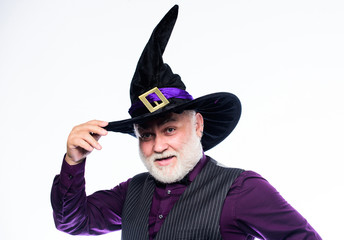 mature man magician in witch hat. bearded man ready for halloween party. evil wizard. Stargazer or...