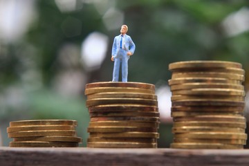 Conceptual Close Up Photo, Standing Man at Rupiah Golden Coin, ilustration for successful or wealth