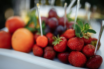 strawberries orange grapes on the table