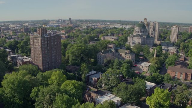 Aerial Push Away From Old Cathedral And Over Historic City Neighborhood