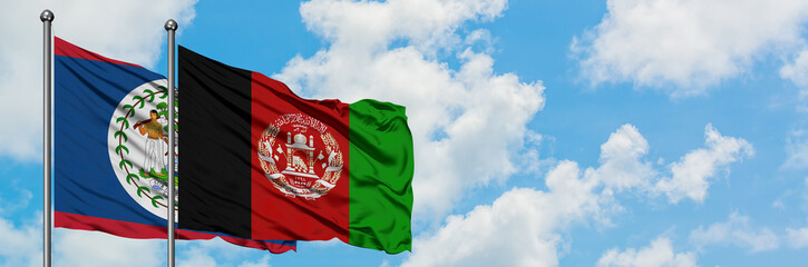 Belize and Afghanistan flag waving in the wind against white cloudy blue sky together. Diplomacy concept, international relations.