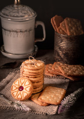 tasty cookies and biscuits in dark moody. Vintage look cookies and biscuit on sack or burlap fabric sheet.