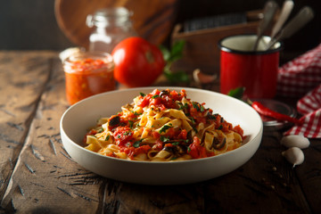 Homemade pasta with tomato sauce and olives