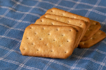 tasty biscuits on blue fabric or napkin