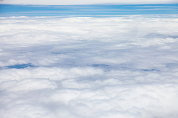 Clouds, sky and ground, looking from the plane.