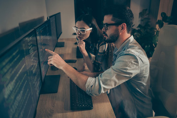 Profile photo of it specialist two serious guy lady business people night together coworking watch direct monitor errors bugs writing interface back-end java script code office indoors