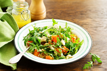 salad with pumpkin, feta and arugula. . Selective focus