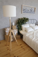 bed with spruce branches in the room decorated for Christmas