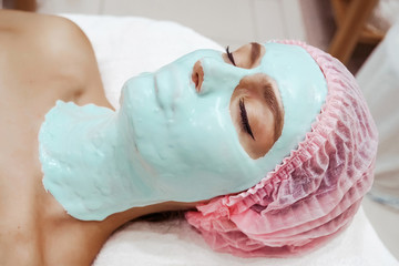  Beautiful woman in a beauty salon, face mask, alginate mask, moisturizing mask, face care, anti-aging mask, natural mask, cosmetologist, cosmetology