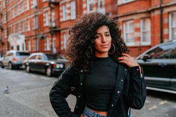 Portrait Charming Young African Woman with Curly Hair, Street Style