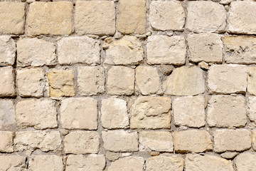 The background old beige wall made of natural stone