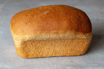 Bread loaf homemade vegan wholemeal on a grey background