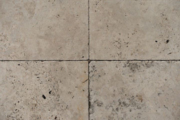 Warm, off-white stone paving texture.