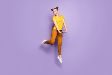 Plakat Full body photo of amazing lady jumping high overjoyed with nice sunny weather day in flirty mood wear yellow t-shirt pants isolated pastel purple background