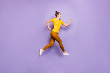 Fototapeta na wymiar Full length profile photo of amazing lady jumping high rushing to finish line championship race wear yellow t-shirt pants isolated pastel purple background