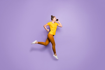 Fototapeta na wymiar Full length body size photo of girlfriend speaking by phone running towards shopping mall known of discounted goods wearing yellow t-shirt brown pants isolated purple violet pastel color background