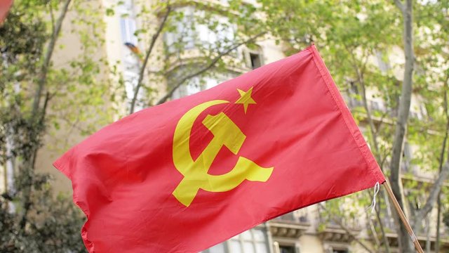 Communist Flag Flying in a Demonstration. Urban environment 02