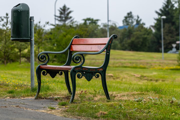 An empty bench next to a waste bin in Reykjavík