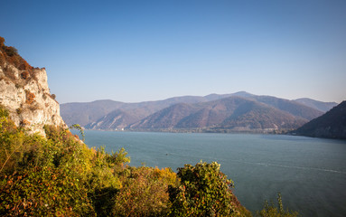 Autumn morning on the river surrounded by mountains. Danube river in Djerdap national park in...