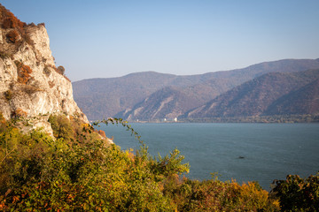 Obraz premium Autumn morning on the river surrounded by mountains. Danube river in Djerdap national park in Serbia on Romanian Border.