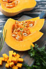 zucca fresca a fette su tagliere di legno sfondo tavolo di cucina verde rustico