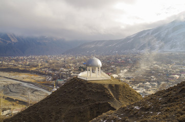 Triumphal rotunda of Sharvili. Scenic view of river and ancient mountain village Akhty. North...