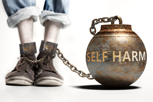 Self harm can be a big weight and a burden with negative influence - Self harm role and impact symbolized by a heavy prisoner's weight attached to a person, 3d illustration