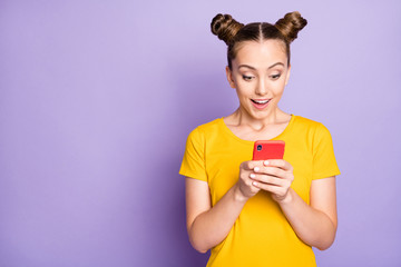Photo of funny model lady holding telephone reading positive comment in social blog wear yellow t-shirt isolated on pastel purple background