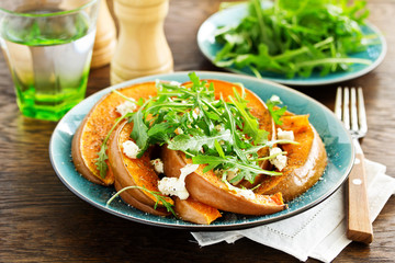 Baked pumpkin with feta and herbs. Selective focus
