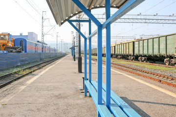 Freight train on the platform. Rail Cargo transit.