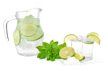 Tequila shot with juicy lime slice and salt on white background