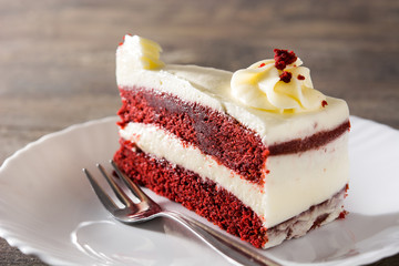 Red velvet cake slice on wooden table