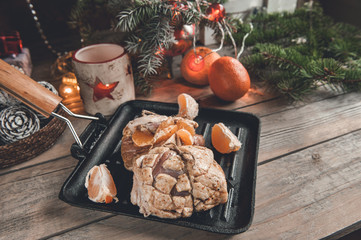 Raw duck breast rolls stuffed with braised tangerines with lettuce leaves. Christmas dishes of the...