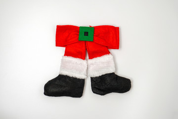  Cheerful legs of santa claus in trousers and boot isolated on white background. New Year and Christmas concept