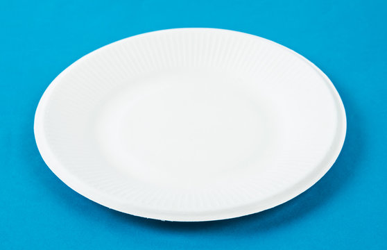 Biodegradable dish dispoable on blue background.