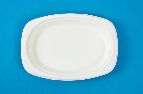 Biodegradable dish dispoable on blue background.